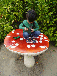 Max on a mushroom statue at the Dierenrijk zoo