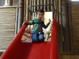 Max on a slide at the playground at the Indoor Apenkooien hall at the Dierenrijk zoo