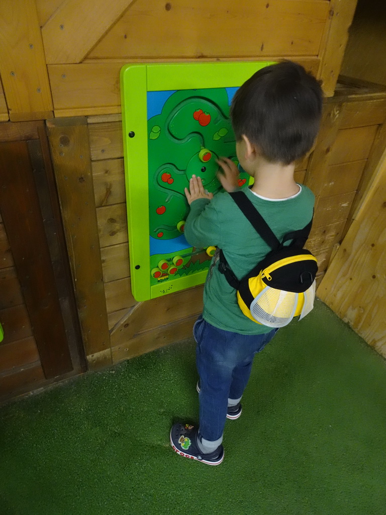 Max doing a puzzle at the playground at the Indoor Apenkooien hall at the Dierenrijk zoo