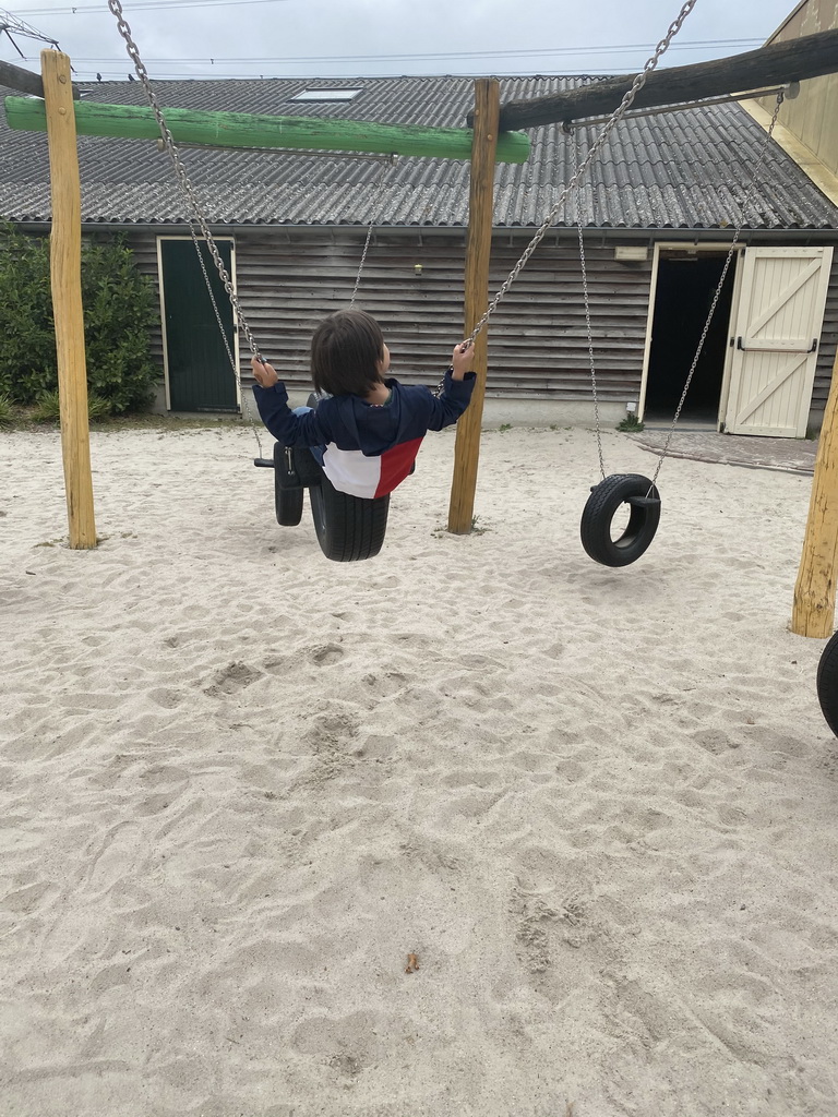 Max on a swing at the playground near Restaurant Smulrijk at the Dierenrijk zoo