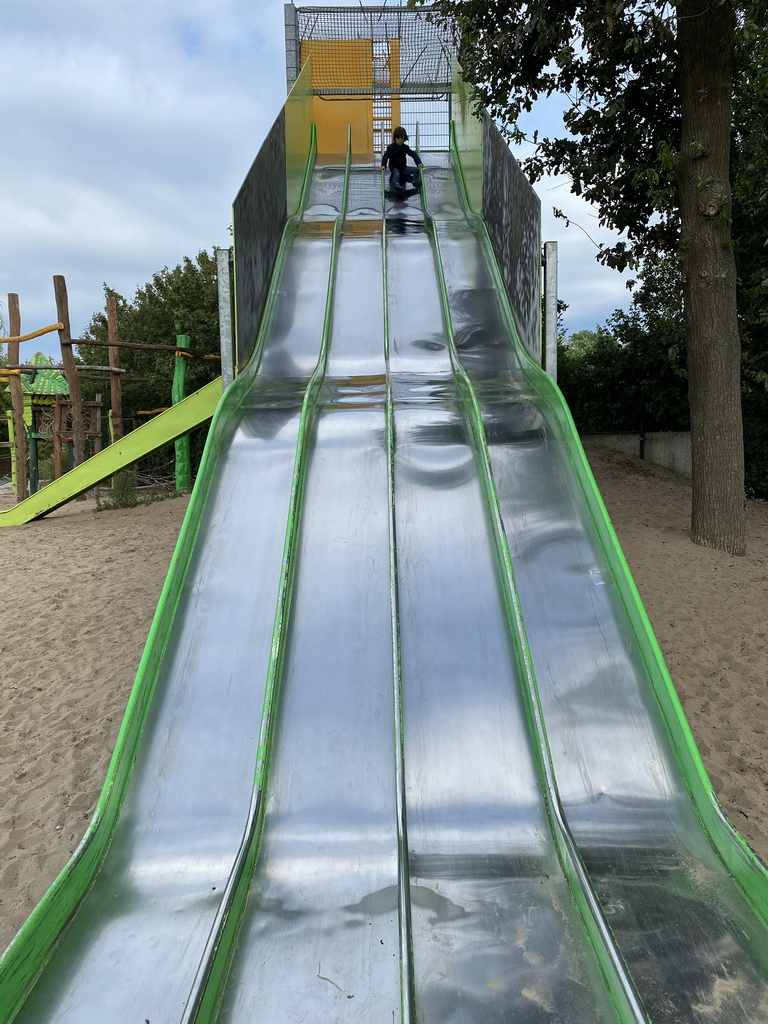 Max on the slide at the playground near Restaurant Smulrijk at the Dierenrijk zoo