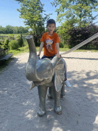 Max on an elephant statue at the playground near the enclosure of the Asian Elephants at the Dierenrijk zoo