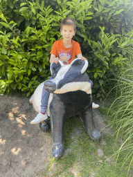 Max on a Badger statue at the Dierenrijk zoo