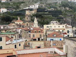 The tower of the Basilica di Santa Trofimena church and buildings at the town center, viewed from the Via Caruseillo street
