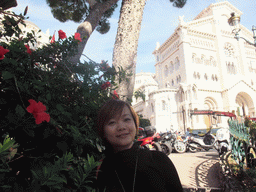 Miaomiao with flowers at the Ruelle Sainte-Barbe alley, and the front of the Saint Nicholas Cathedral