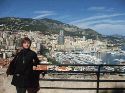 Miaomiao with the skyline of Monte Carlo and the Port Hercule harbour, viewed from the Place du Palais square