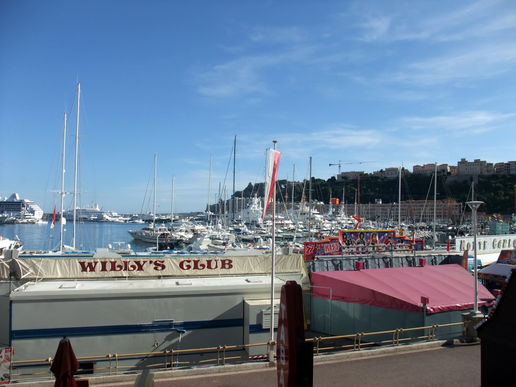 Boats in the Port Hercule harbour and funfair stalls