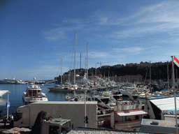 Boats in the Port Hercule harbour and funfair stalls