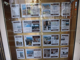Posters on the window of a real estate agent in shopping centre Le Métropole