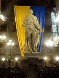 Statue of Sébastien Auguste Baussan and banner at the Église Saint Roch church