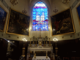 Apse with main altar, paintings and a stained glass window of St. Roch walking with his dog to the Montpellier Cathedral, at the Église Saint Roch church