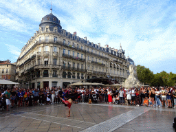 Breakdancer in front of the Three Graces Fountain at the Place de la Comédie square