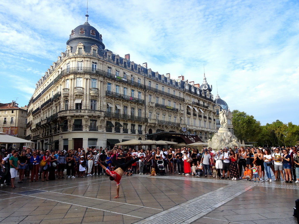 Breakdancer in front of the Three Graces Fountain at the Place de la Comédie square