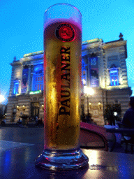 Paulaner beer at the terrace of the Le Yam`s restaurant at the Place de la Comédie square, with a view on the front of the Opéra National de Montpellier, at sunset