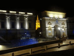 Back side of the Porte du Peyrou arch and the tower of the Église Sainte Anne church, viewed from the Rue la Blottière street, by night