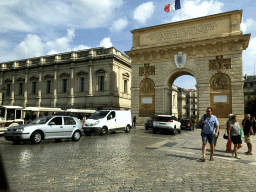 Tourist train and back side of the Porte du Peyrou arch at the Rue François Franque street, viewed from the taxi to the airport