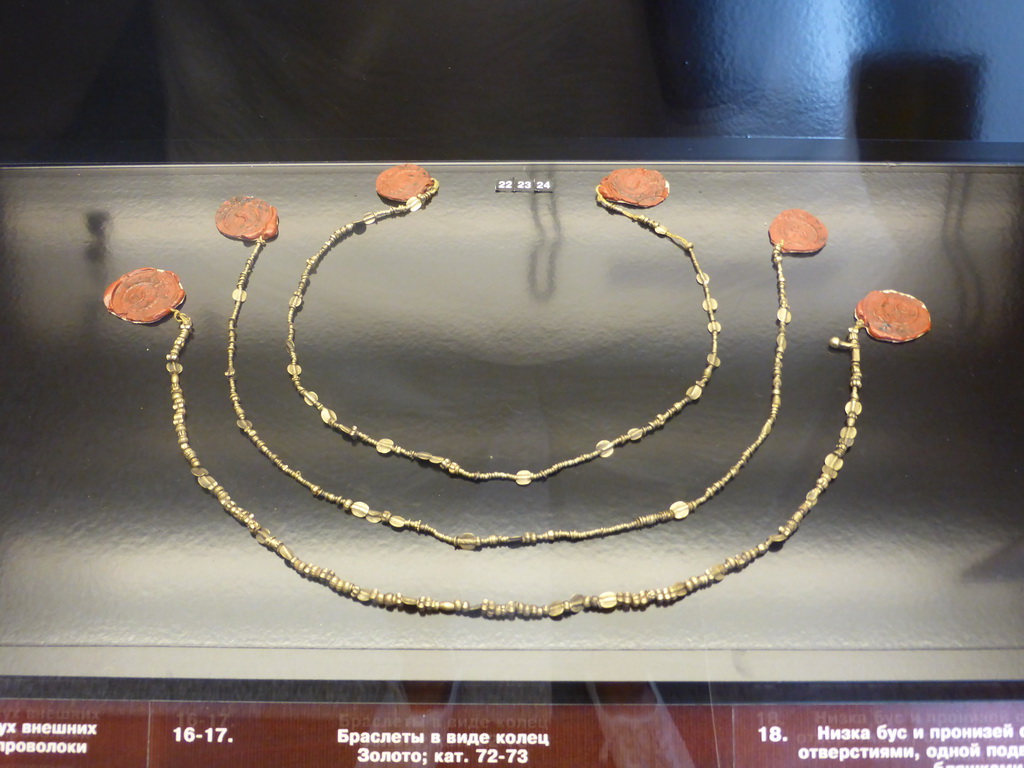 Pendants, part of Priam`s Treasure, at Room 3: Ancient Troy and Schliemann`s excavations at the Ground Floor of the Pushkin Museum of Fine Arts, with explanation