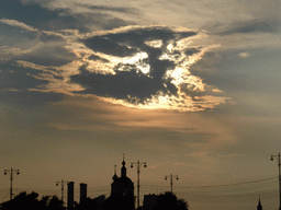 Sun behind the clouds above the towers of the Church of St. Nicholas at Zayaitsky, viewed from the tour boat on the Moskva river