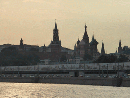 The Moscow Kremlin with the Spasskaya Tower and Saint Basil`s Cathedral, viewed from the tour boat on the Moskva river