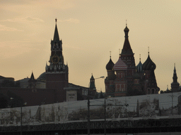 The Spasskaya Tower of the Moscow Kremlin and Saint Basil`s Cathedral, viewed from the tour boat on the Moskva river