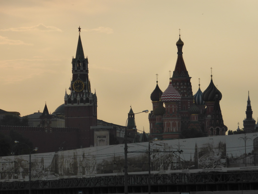 The Spasskaya Tower of the Moscow Kremlin and Saint Basil`s Cathedral, viewed from the tour boat on the Moskva river