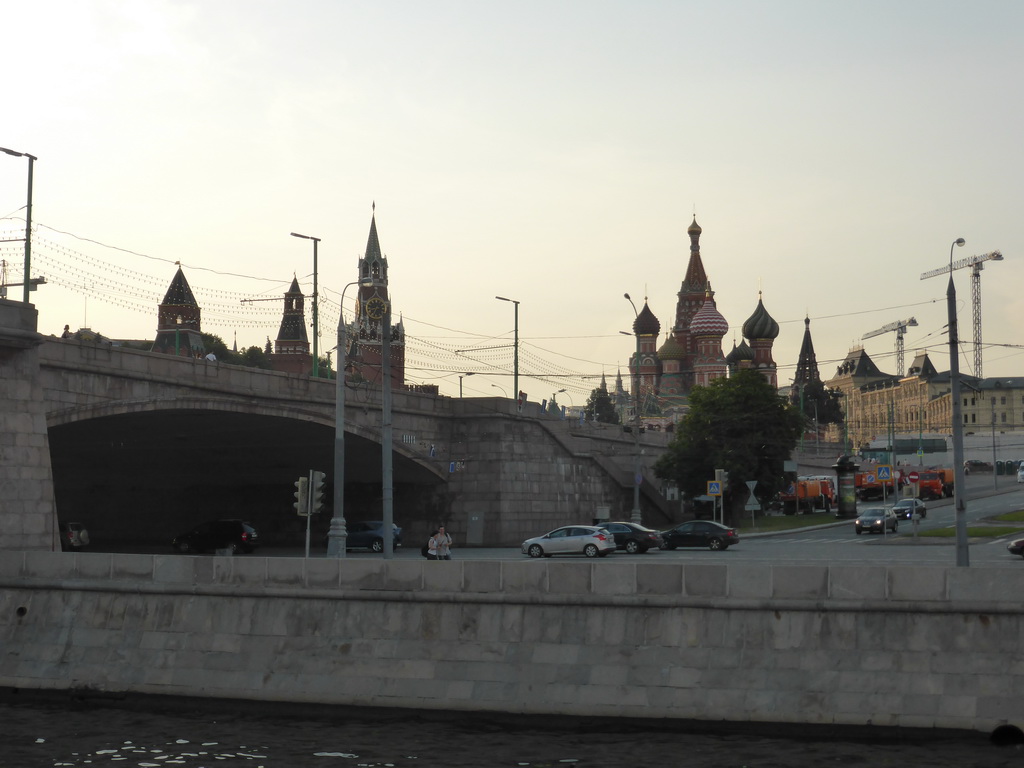 The Bolshoy Moskvoretsky Bridge over the Moskva river, the Moscow Kremlin with the Spasskaya Tower and Saint Basil`s Cathedral, viewed from the tour boat