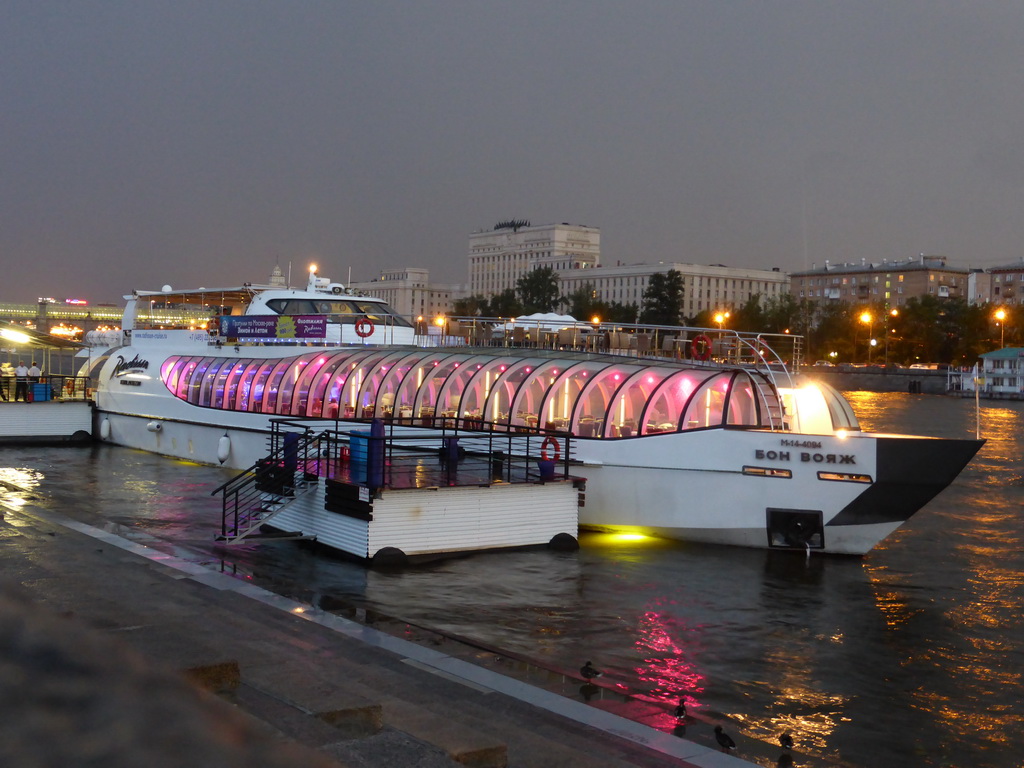 Our tour boat in the Moskva river at the dock near Krymsky Bridge, and the Main Command of the Ground Forces of the Russian Federation building, at sunset