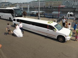 Limousine for a wedding party at Bolotnaya Square and fountains in the Vodootvodny Canal, viewed from the sightseeing bus
