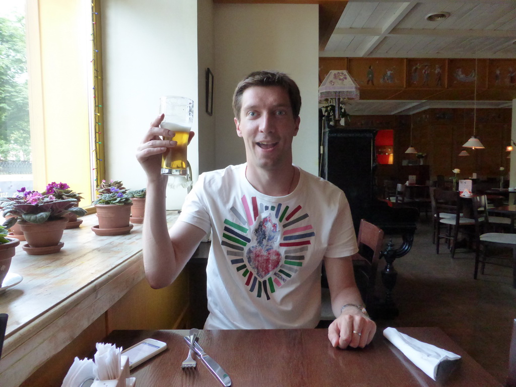 Tim with a beer at the Deti Rayka restaurant at Nikitskiy Boulevard