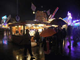 Friends having snacks at the Oktoberfest terrain at the Theresienwiese square, by night