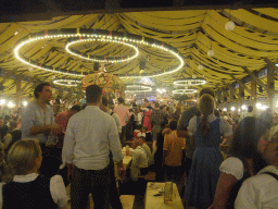 People celebrating the Oktoberfest festival in the Paulaner tent at the Oktoberfest terrain at the Theresienwiese square