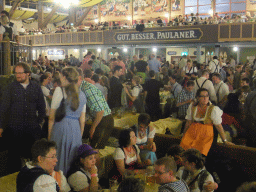People celebrating the Oktoberfest festival in the Paulaner tent at the Oktoberfest terrain at the Theresienwiese square