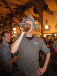 Friend with a beer, and people celebrating the Oktoberfest festival in the Paulaner tent at the Oktoberfest terrain at the Theresienwiese square