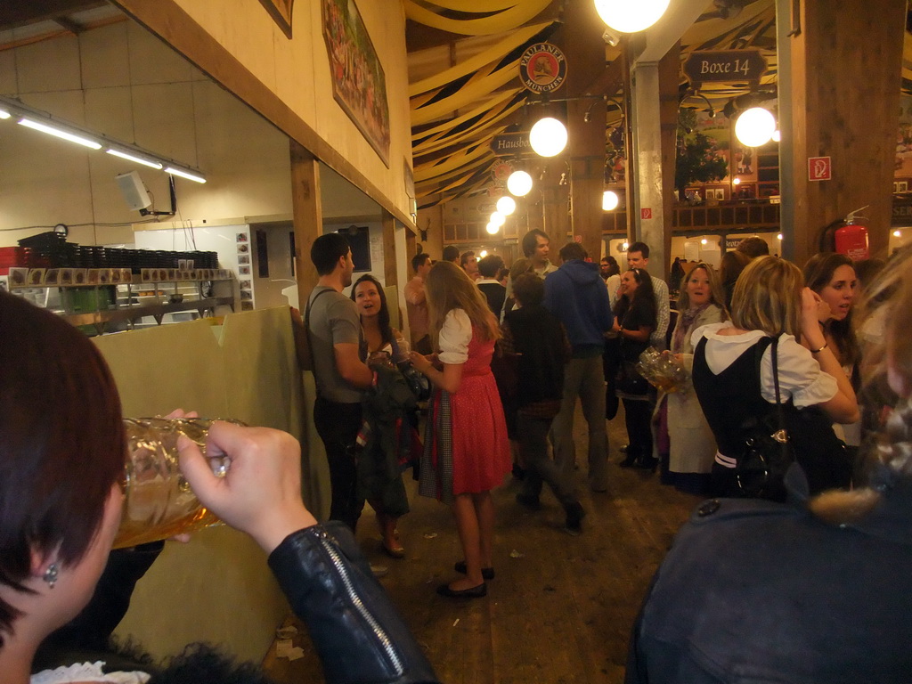 Miaomiao with a beer, and people celebrating the Oktoberfest festival in the Paulaner tent at the Oktoberfest terrain at the Theresienwiese square, during closing time