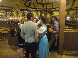 People celebrating the Oktoberfest festival in the Paulaner tent at the Oktoberfest terrain at the Theresienwiese square, during closing time