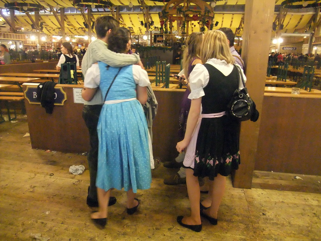 People celebrating the Oktoberfest festival in the Paulaner tent at the Oktoberfest terrain at the Theresienwiese square, during closing time