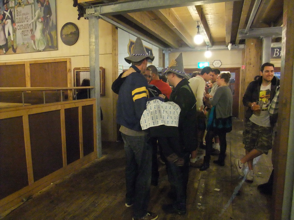 Friends in the Paulaner tent at the Oktoberfest terrain at the Theresienwiese square, during closing time