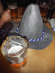 Hat and beer on a table at the Oktoberfest party at the Löwenbräukeller beer hall