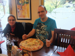 Friends having pizza in a restaurant along the road to Nijmegen