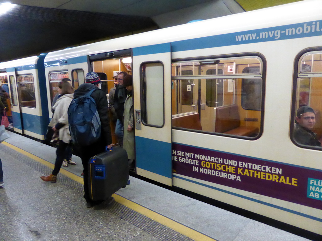 People getting in and out of the metro train at the metro station Sendlinger Tor