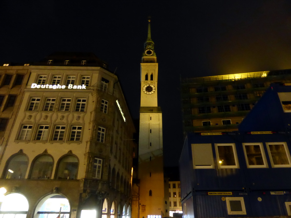 The Rindermarkt street and the tower of St. Peter`s Church, viewed from the Marienplatz square, by night