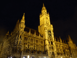 Left front and tower of the Neues Rathaus building, viewed from the Marienplatz square, by night