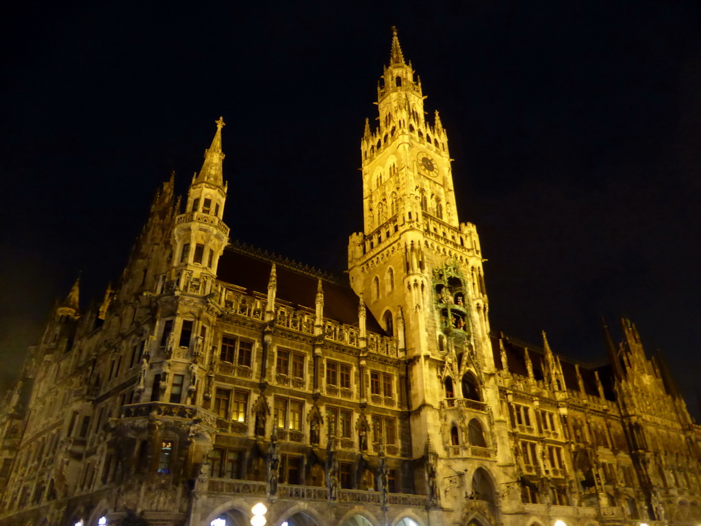 Left front and tower of the Neues Rathaus building, viewed from the Marienplatz square, by night
