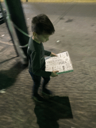 Max with a pizza box at the Via Nazionale delle Puglie street, by night