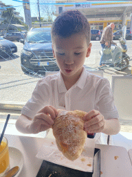 Max eating bread at the Azzurro Pasticceria bakery