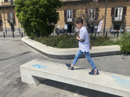 Max walking on a bench at the Riviera di Chiaia street