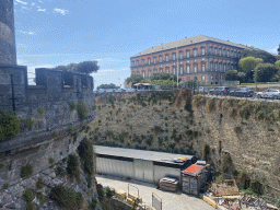 Southwest side and moat of the Castel Nuovo castle and the northeast side of the Royal Palace of Naples, viewed from the access bridge