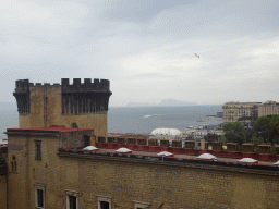 Southeast side of the Castel Nuovo castle with the Gold Tower, the Porticciolo di Santa Lucia marina, the Gulf of Naples and the island of Capri, viewed from the northwest side of the roof