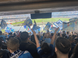 Football fans at the Curva A Inferiore grandstand and players entering the pitch at the Stadio Diego Armando Maradona stadium, just before the football match SSC Napoli - Salernitana