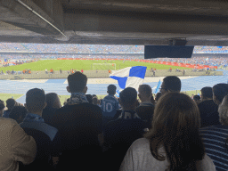 Football fans at the Curva A Inferiore grandstand and players on the pitch at the Stadio Diego Armando Maradona stadium, during the football match SSC Napoli - Salernitana